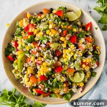 Festive Mexican-Style Fiesta Rice Recipe 9 Large bowl of fiesta rice garnished with cilantro and lime wedges.