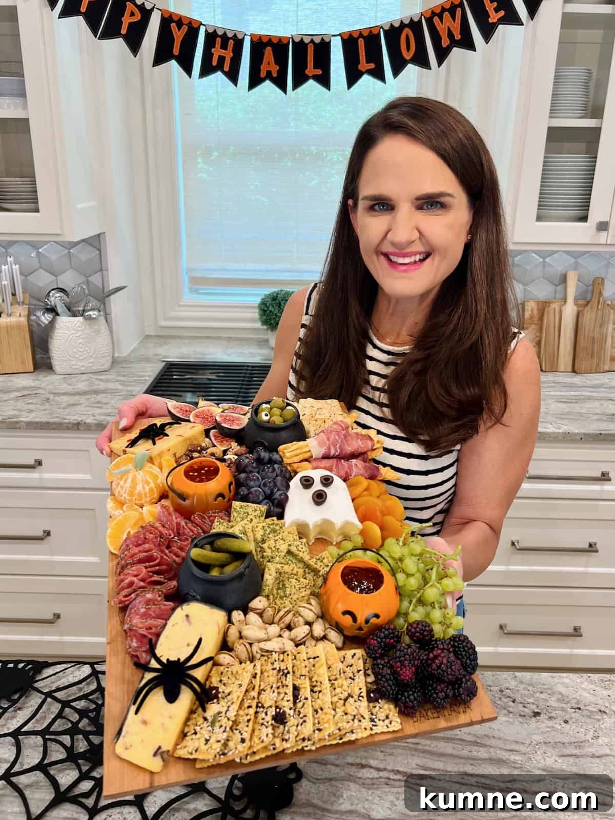 Halloween Guest Signature Board Ideas for Parties and Events 3 Maegan Brown holding her Halloween Signature board.