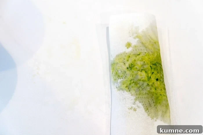 Ultimate Moist Zucchini Bread Recipe for Perfect Loaves Every Time 3 A sheet of folded paper towels absorbing the moisture of shredded zucchini to bake with.