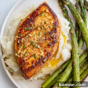 garlic butter tofu plated with mashed potatoes and roasted asparagus