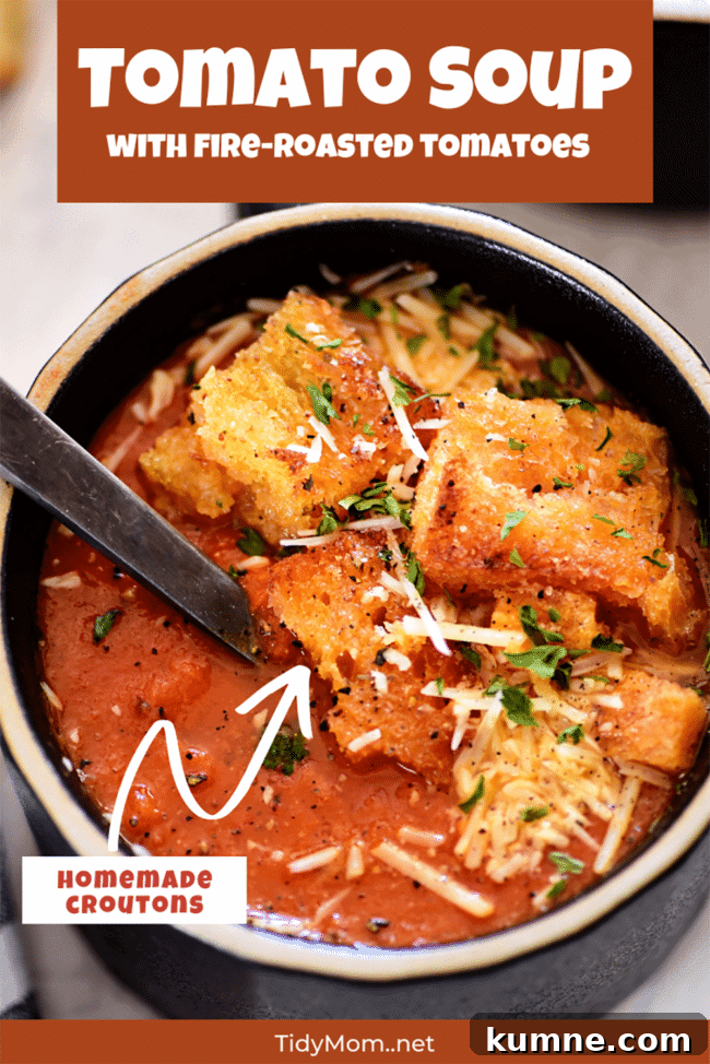 delicious tomato soup in a black bowl with croutons