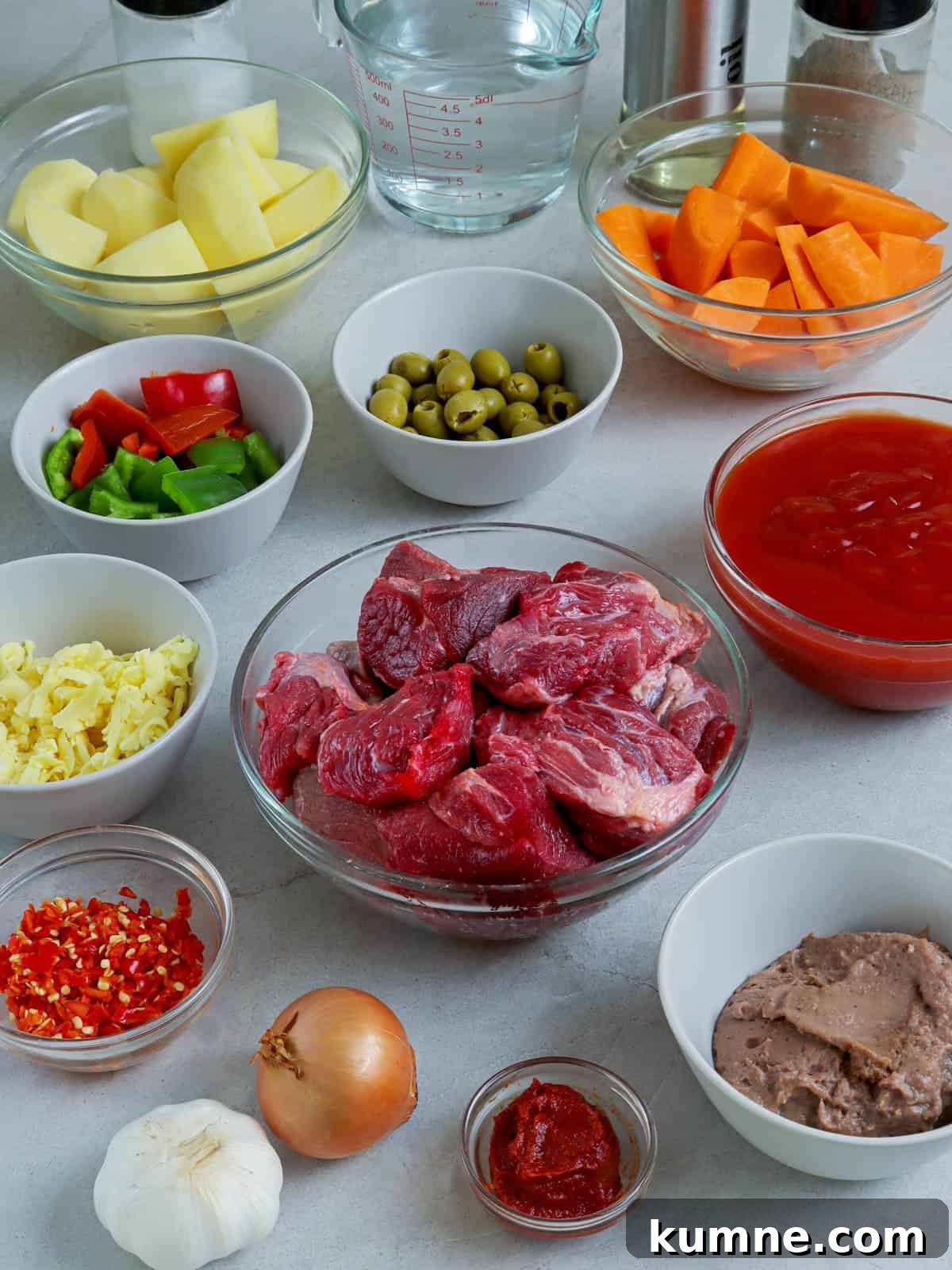 beef cubes, bell peppers, potatoes, carrots, liver spread, shredded cheese, tomato sauce, onions, garlic, olives