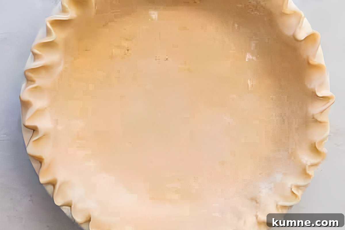 Authentic Dutch Apple Pie Recipe: Classic Ouderwets Appeltaart Guide 11 crimped pie crust in a pie dish.