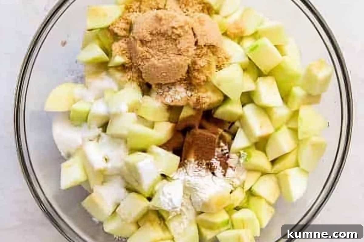 Authentic Dutch Apple Pie Recipe: Classic Ouderwets Appeltaart Guide 12 chopped apples and spices in a glass bowl.