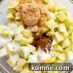 Authentic Dutch Apple Pie Recipe: Classic Ouderwets Appeltaart Guide 6 chopped apples and spices in a glass bowl.