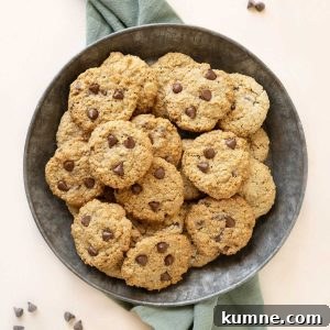 Chewy Chocolate Chip Oatmeal Cookies Recipe for Homemade Treats 10 Close up of metal plate with piled chocolate chip oatmeal cookies. Green cloth beneath it. Light peach surface.