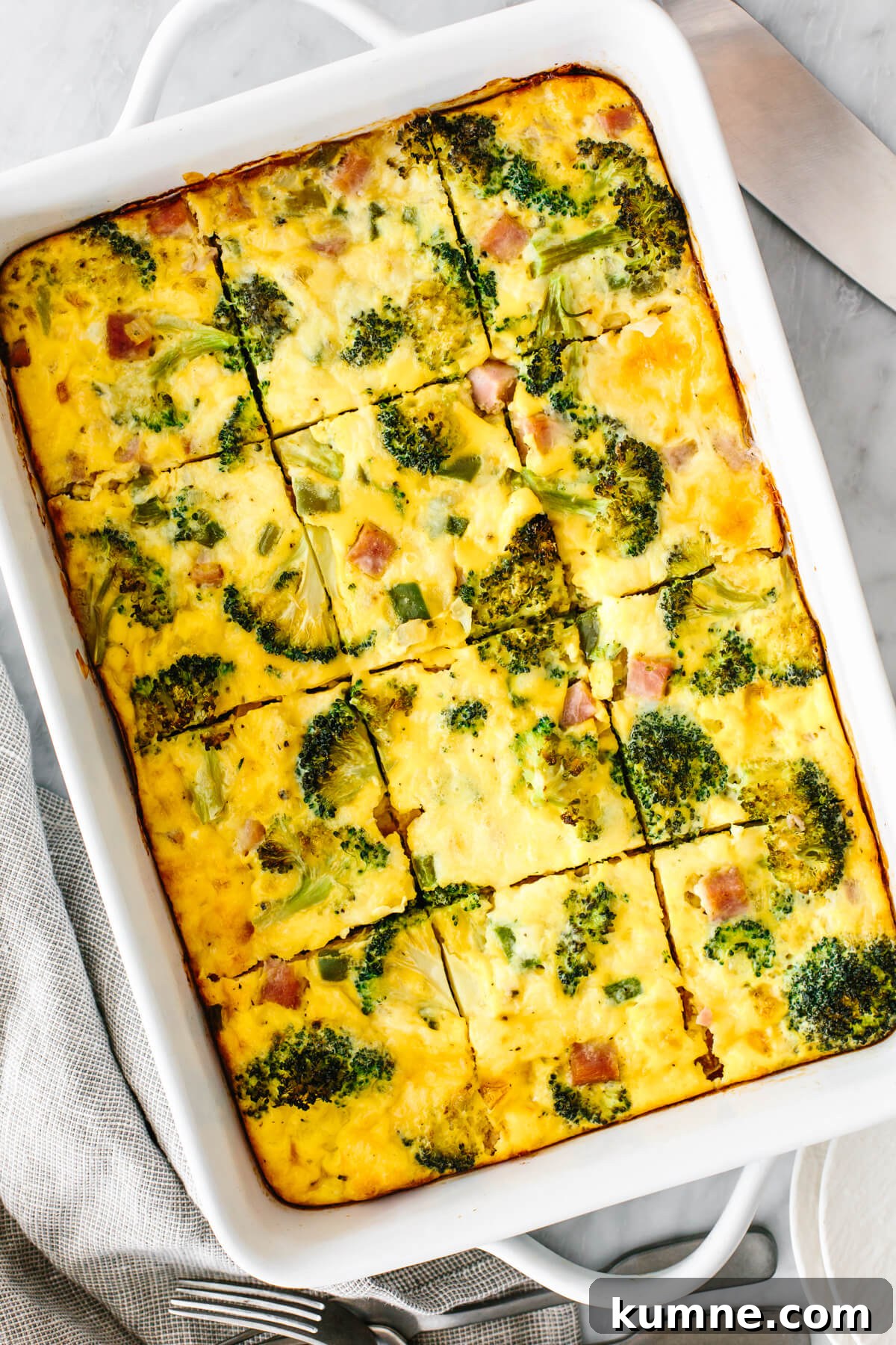 A breakfast casserole next to utensils