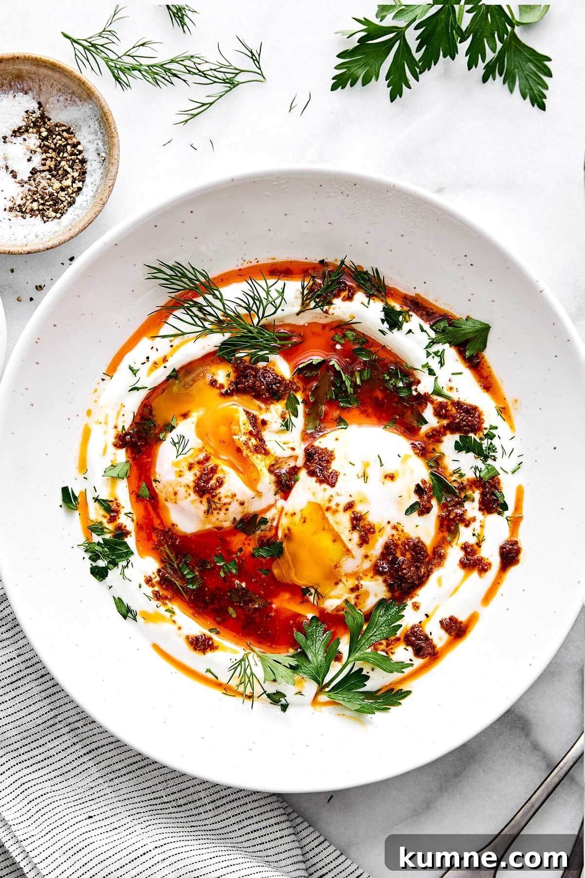 A plate of Turkish eggs with herbs.