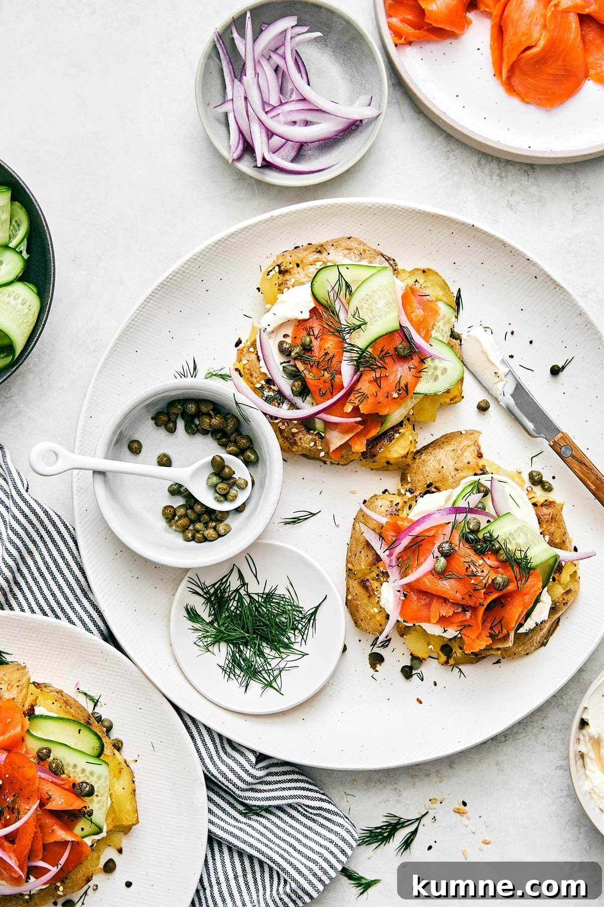 Smashed potatoes lox bagel on a plate.