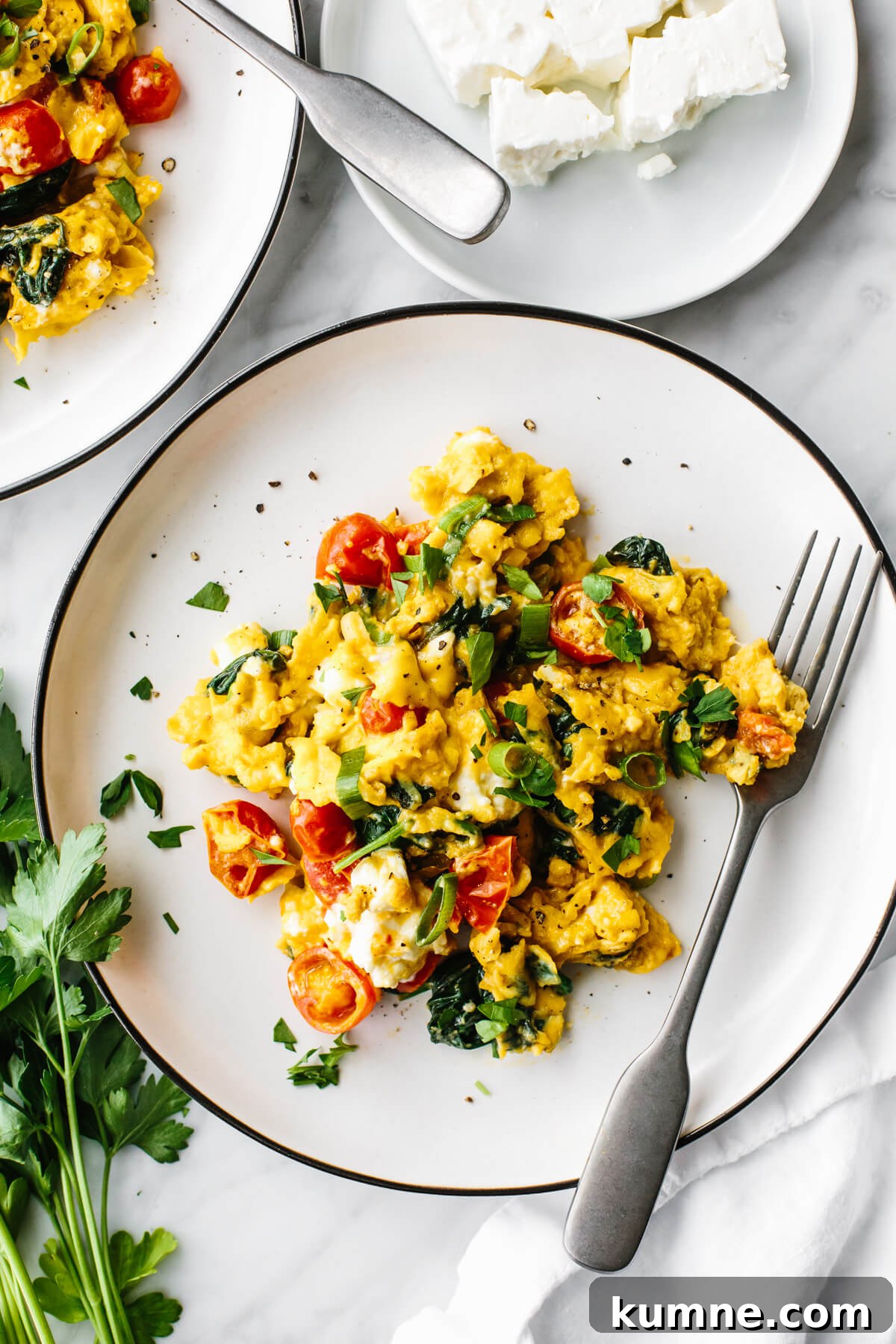Greek scrambled eggs on a white plate