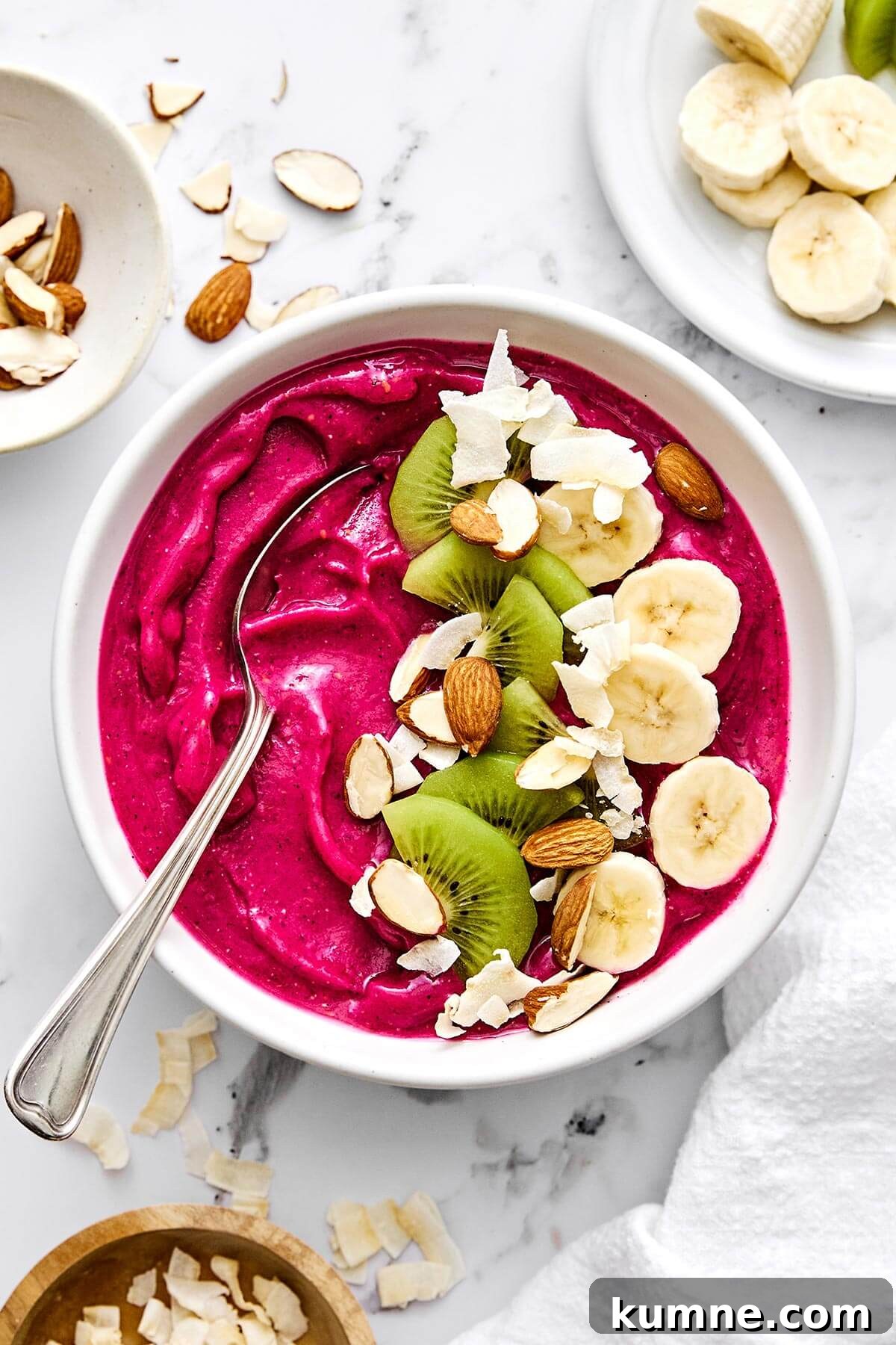 Pitaya smoothie bowl with fruits on top.