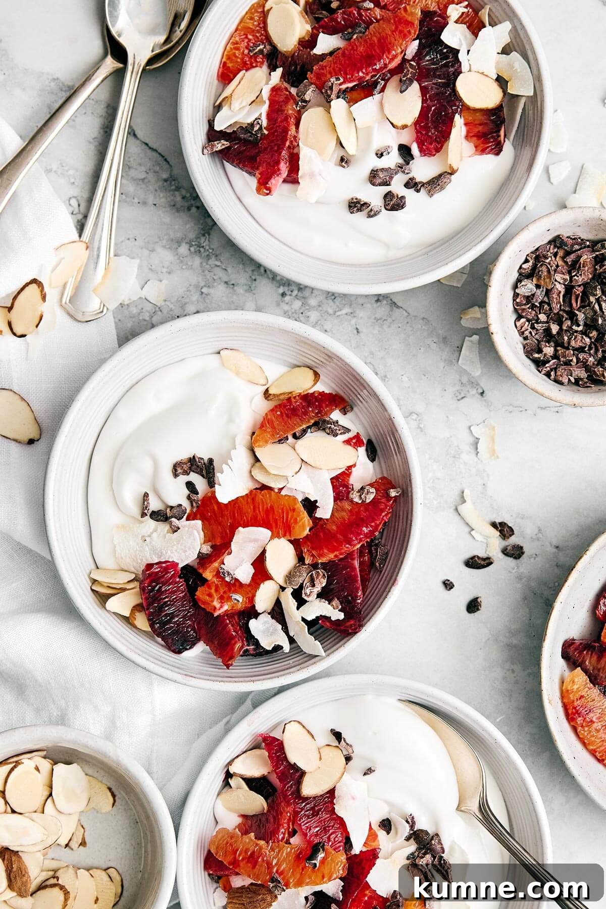 Coconut yogurt bowls with fruit and cacao nibs.