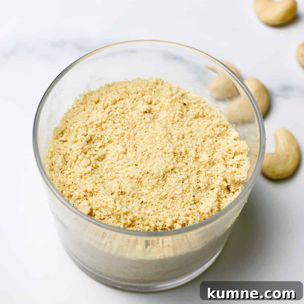 A glass filled with nutty cheese topping