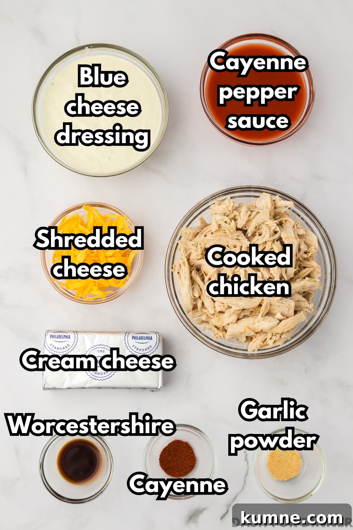 Slow Cooker Buffalo Chicken Dip Recipe for Game Day Snacks 3 The ingredients needed to make buffalo chicken dip, including cayenne pepper sauce, blue cheese dressing, cream cheese, cheddar cheese, and cooked chicken.