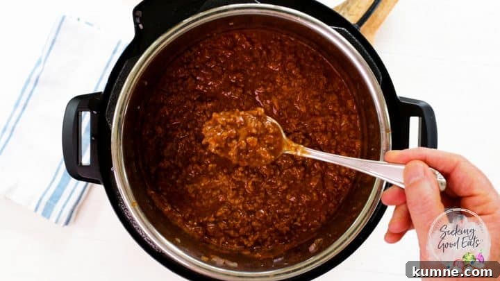 Instant Pot Sloppy Joes Recipe — Quick Comfort Dinner 6 A spoon is dishing out some of the sloppy joes mixture from the pressure cooker pot