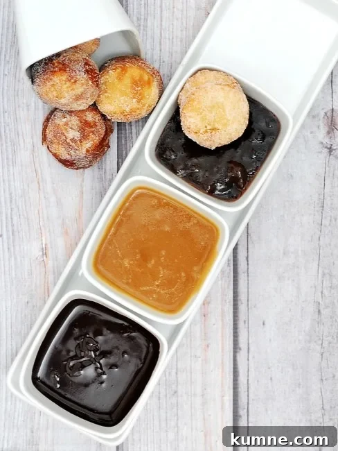 Donut Holes with Three Irresistible Dipping Sauces for Brunch 6 #BrunchWeek continues with sweet sugar-covered fried donut holes, served with three dipping sauces: caramel, chocolate, and blackberry. Bet you can't stop at just one! theredheadbaker.com