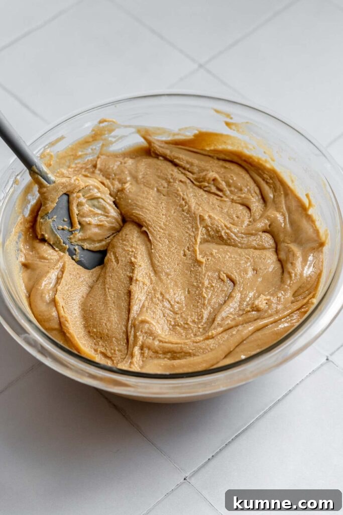 Peanut Butter Marshmallow Fluff Fudge (Fluffernutter) 8 Thickening fudge in a bowl.