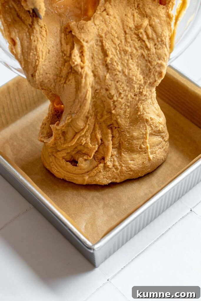 Peanut Butter Marshmallow Fluff Fudge (Fluffernutter) 9 Fluffernutter fudge being poured into a baking pan.