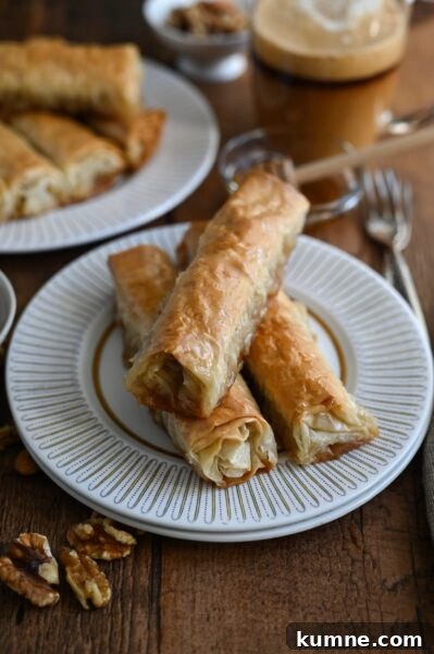 Saragli or Baklava cigars are a traditional Greek syrup soaked dessert make with phyllo dough and nuts