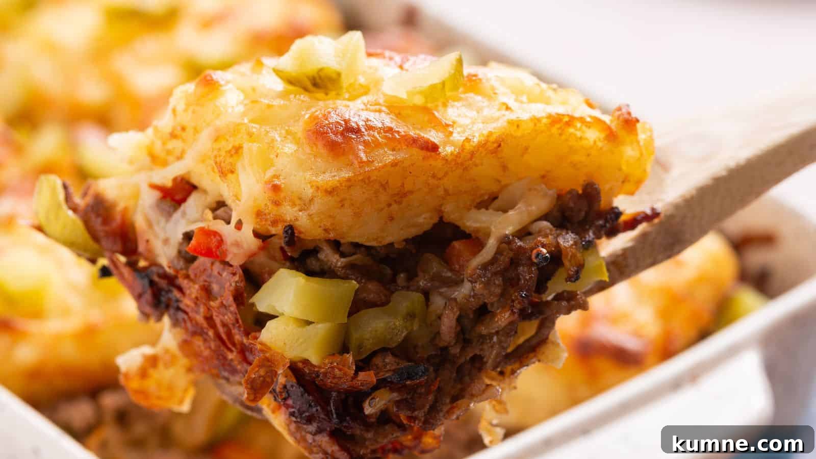 Cheesy hashbrown topped casserole in baking pan.