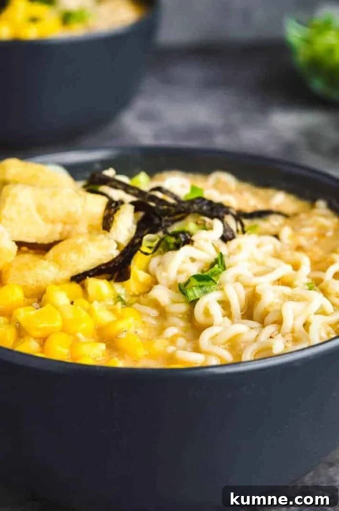 Quick 15-Minute Vegan Miso Ramen Recipe 2 Side view of two gray bowls full of creamy broth, ramen noodles, spring onions, tofu and sweetcorn