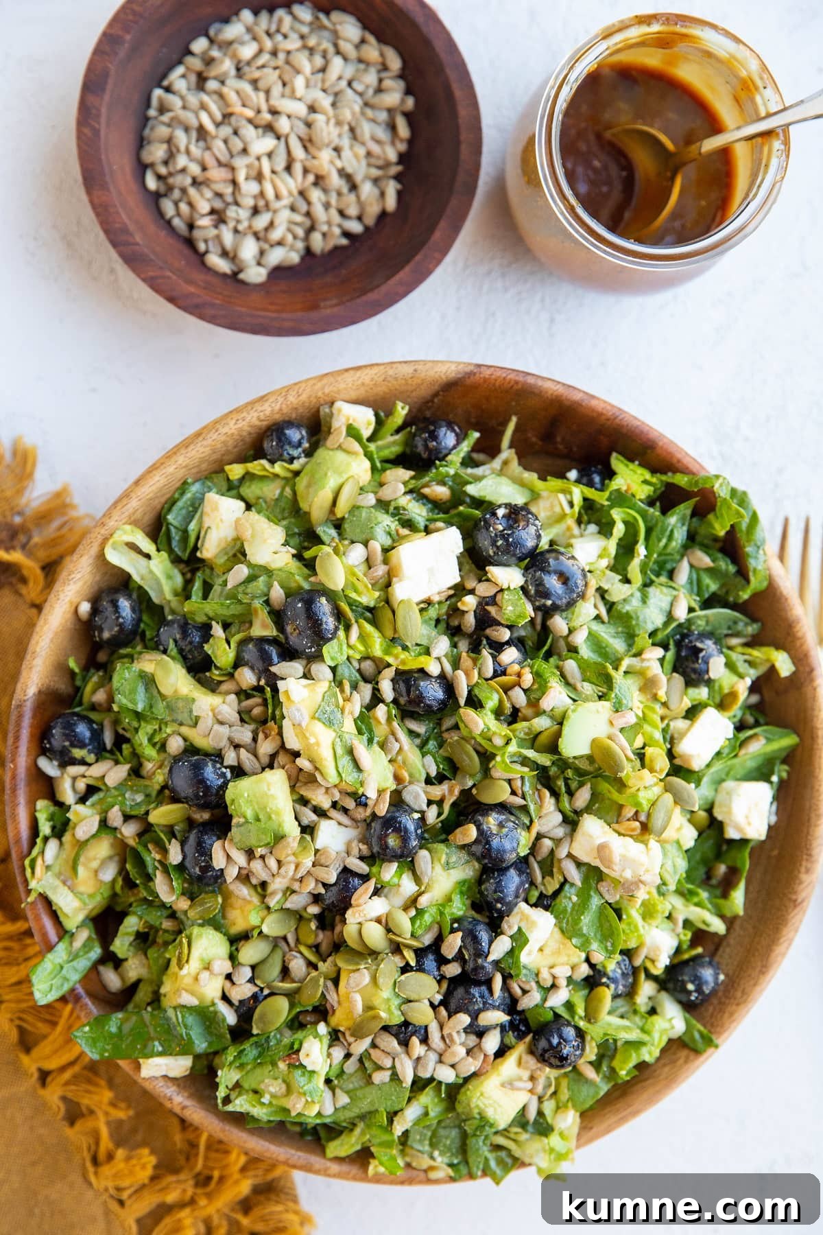 38-Day Balanced Meal Plan for Lasting Energy and Weight Control 6 Bowl of green salad with blueberries, avocado, sunflower seeds, feta cheese, pumpkin seeds and balsamic vinaigrette mixed in.