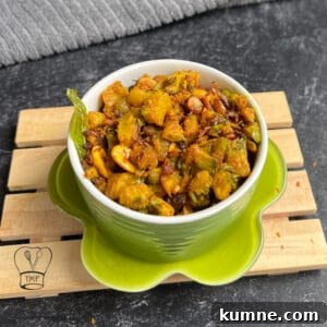 Crispy Bitter Gourd Stir-Fry (Pavakkai Poriyal) 4 Delicious bitter gourd stir fry served in a green bowl, perfect for traditional South Indian cuisine.