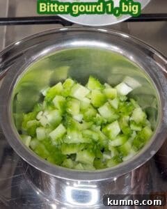 Crispy Bitter Gourd Stir-Fry (Pavakkai Poriyal) 6 Bitter gourd pieces in a stainless steel bowl, ready for cooking.
