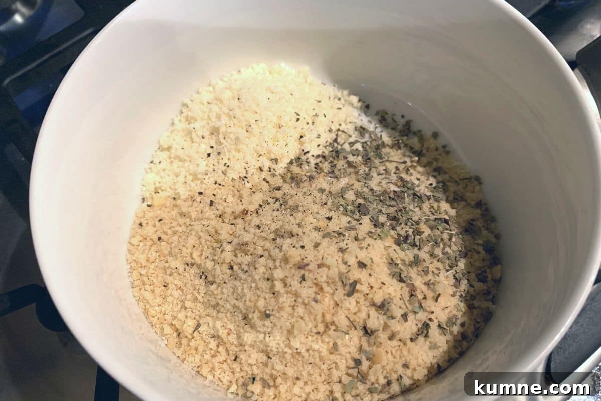 Gluten free panko, parmesan, and seasonings in a small bowl ready to mix.