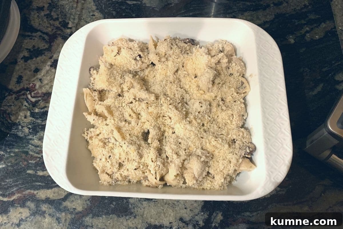 A casserole dish filled with unbaked tuna casserole.