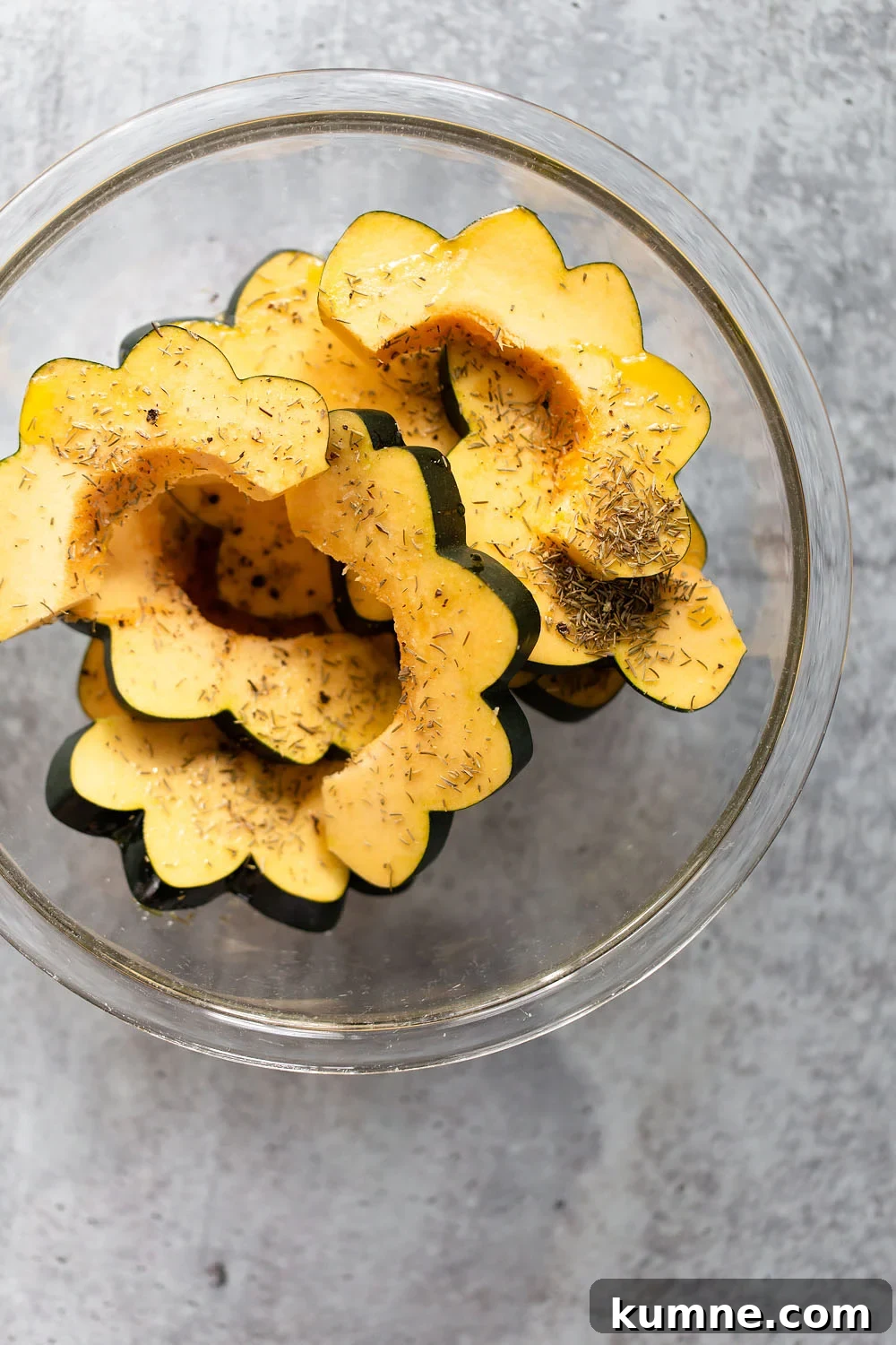 Crispy Roasted Acorn Squash with Parmesan and Herbs 5 acorn squash with spices in a bowl