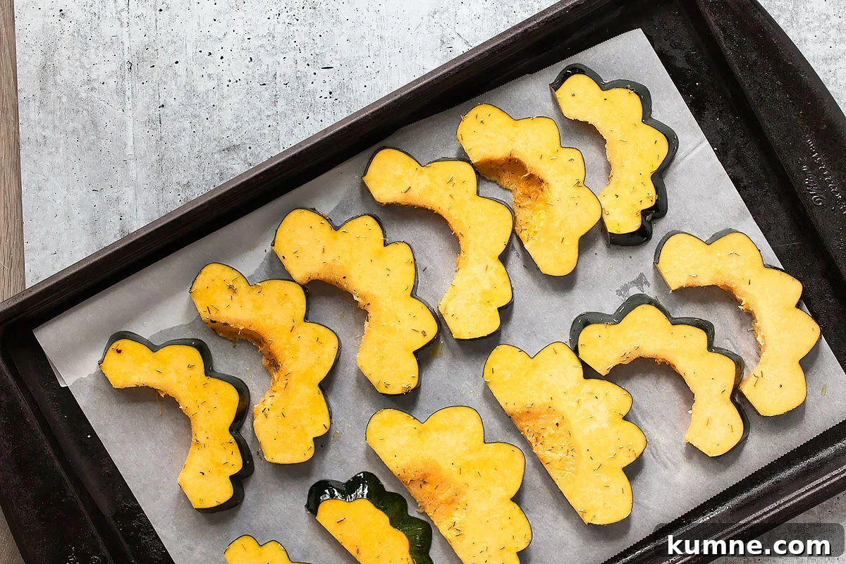 Crispy Roasted Acorn Squash with Parmesan and Herbs 6 acorn squash slices on a cookie sheet