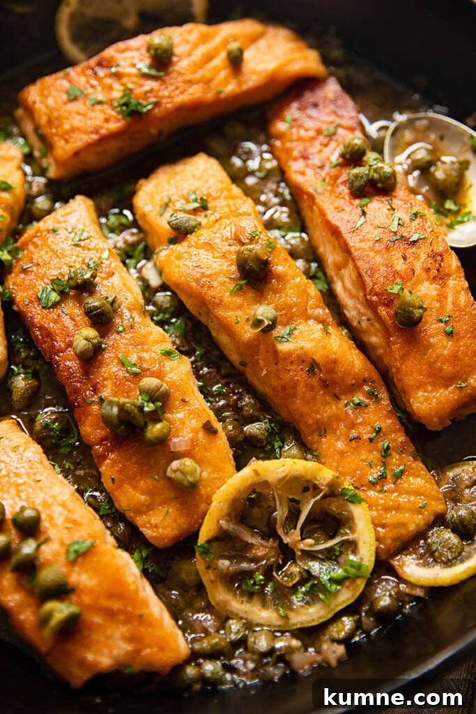 Lemon Caper Salmon Piccata Recipe with Garlic Butter Sauce 2 pan seared salmon topped with capers and lemon slices