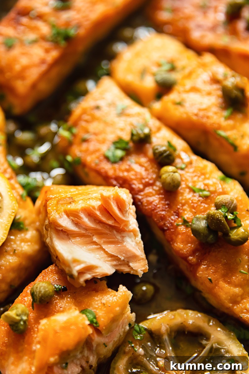 Lemon Caper Salmon Piccata Recipe with Garlic Butter Sauce 3 close up of salmon pieces topped with capers and parsley