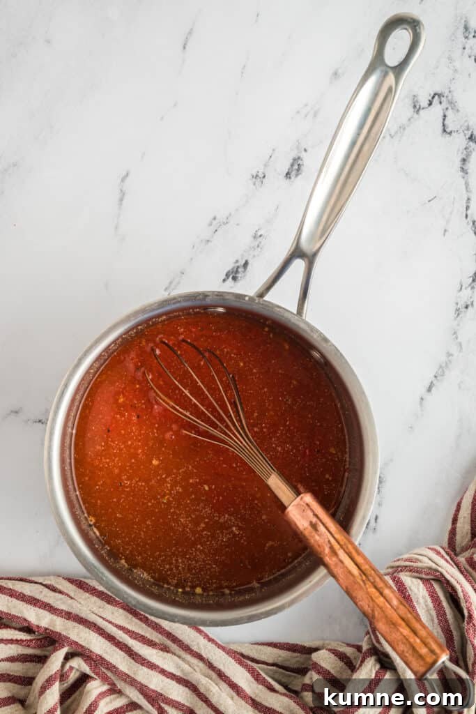 Heat over medium, whisking frequently until the sugar has dissolved and the sauce is just starting to simmer. 