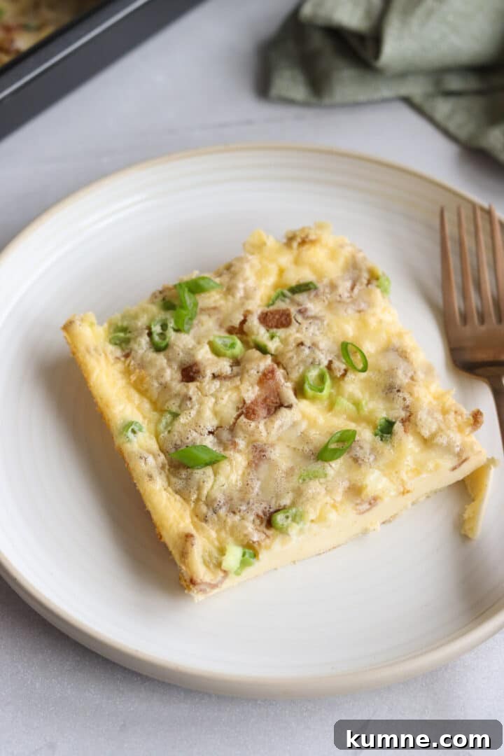 Cottage Cheese Frittata with Eggs and Herbs 2 Slice of cottage cheese egg bake on a white plate, garnished with sliced green onions