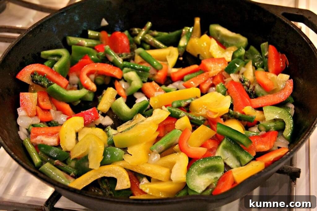 Sauteing vegetables in a large cast-iron skillet to make a frittata.