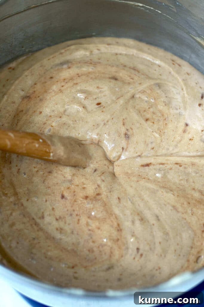 finished cake batter in a mixing bowl with a spatula