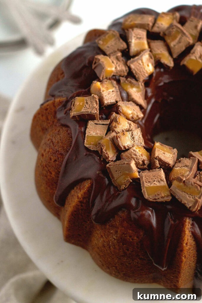 Milky Way cake with chocolate ganache glaze and chopped candy on top