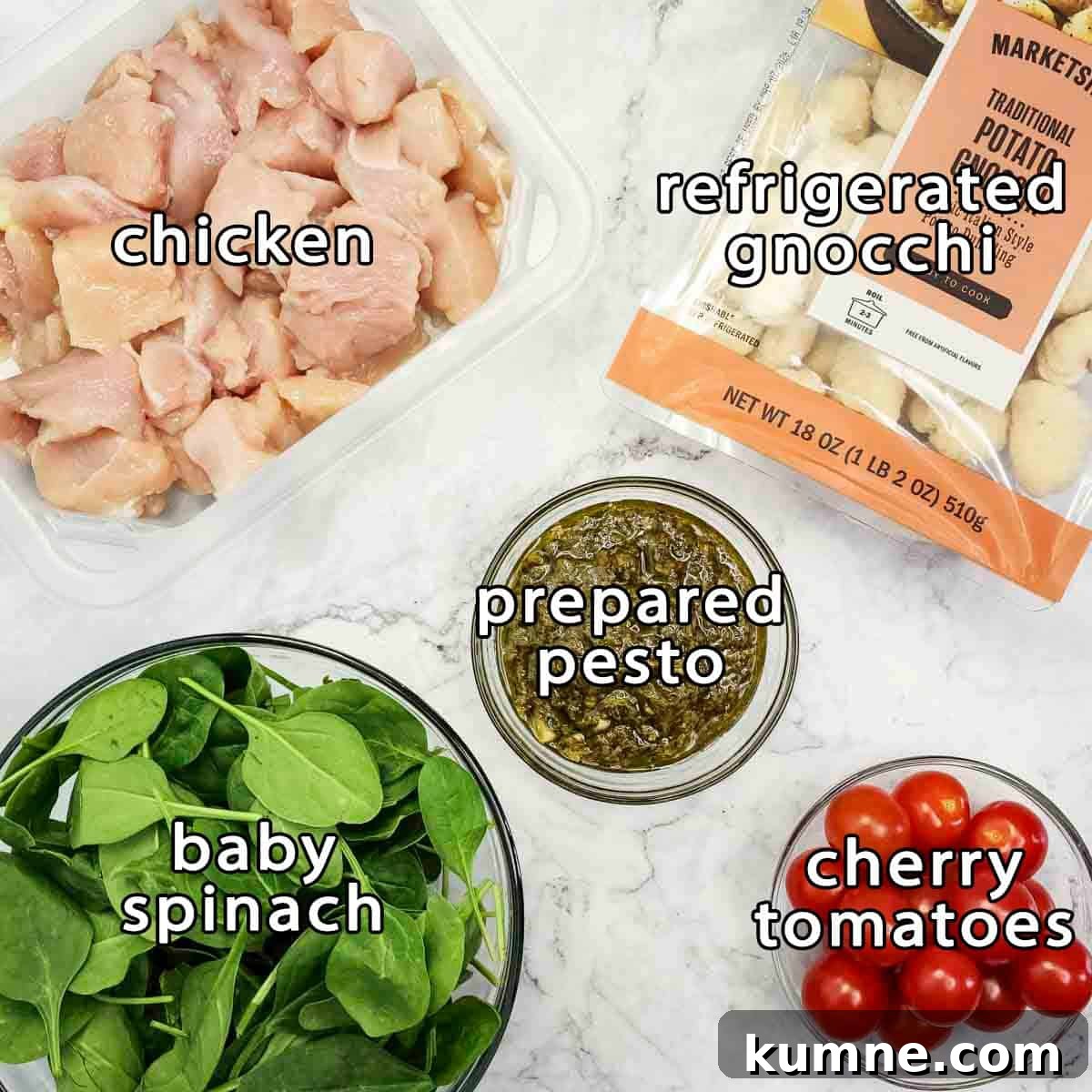 Overhead shot of ingredients - chicken, refrigerated gnocchi, prepared pesto, baby spinach, and cherry tomatoes.
