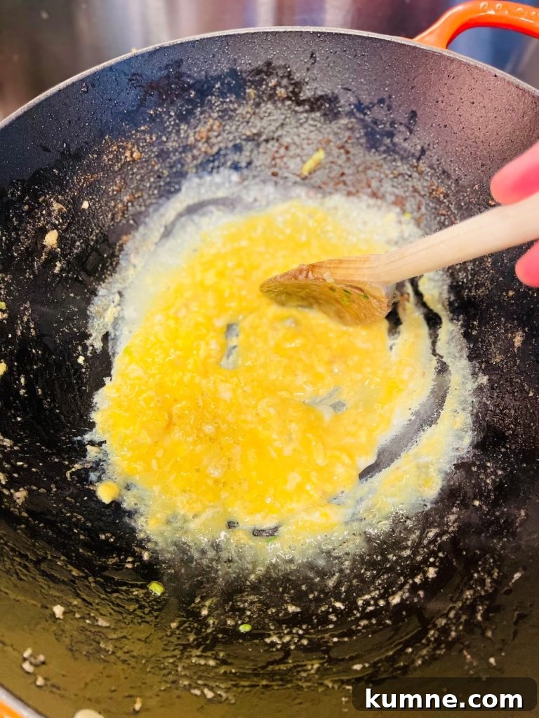 Chicken Fried Rice Recipe: Quick Homemade Takeout-Style Meal 6 Mixing egg into the pan