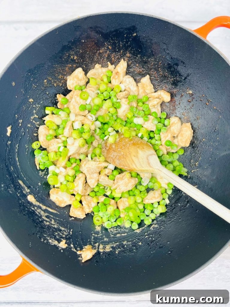 Chicken Fried Rice Recipe: Quick Homemade Takeout-Style Meal 5 Pan with spring onions, peas and cooked chicken