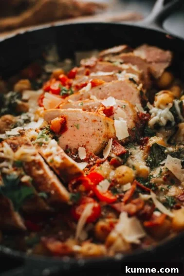 Close up of sliced pork tenderloin in skillet with gnocchi