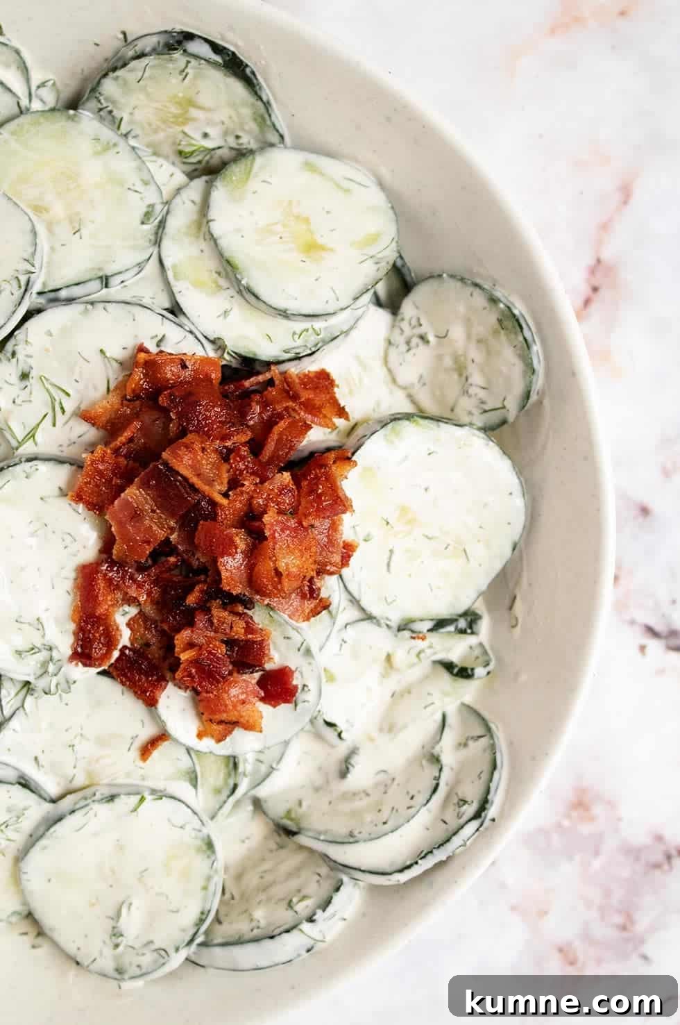 Keto Cucumber and Bacon Salad with Creamy Dill Dressing 2 overhead view of keto cucumber salad with crumbled bacon on top