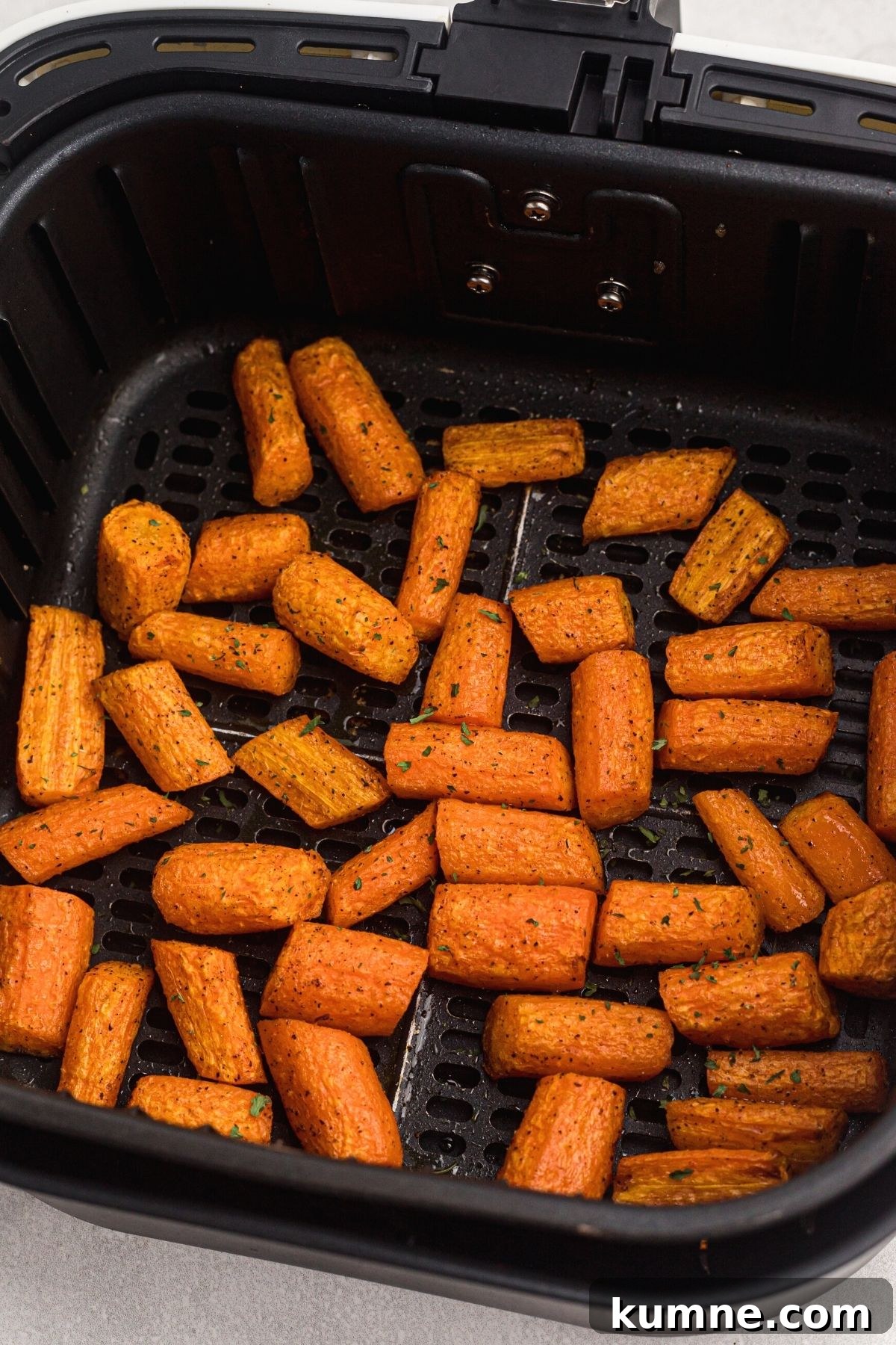 Seasoned carrots cooked in the air fryer basket.