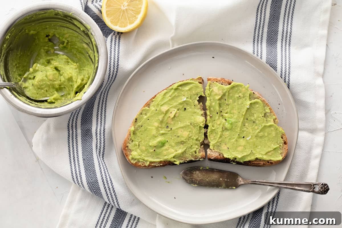Copycat Dunkin' Avocado Toast Recipe with 3 Ingredients 2 Sourdough bread with avocado spread on top cut in half