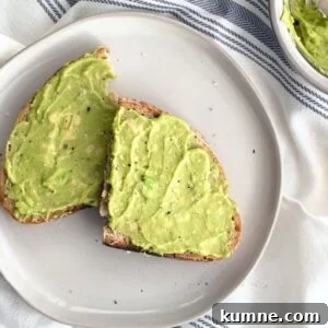 Copycat Dunkin' Avocado Toast Recipe with 3 Ingredients 15 Avocado toast with flaky sea salt and cracked black pepper on a white plate