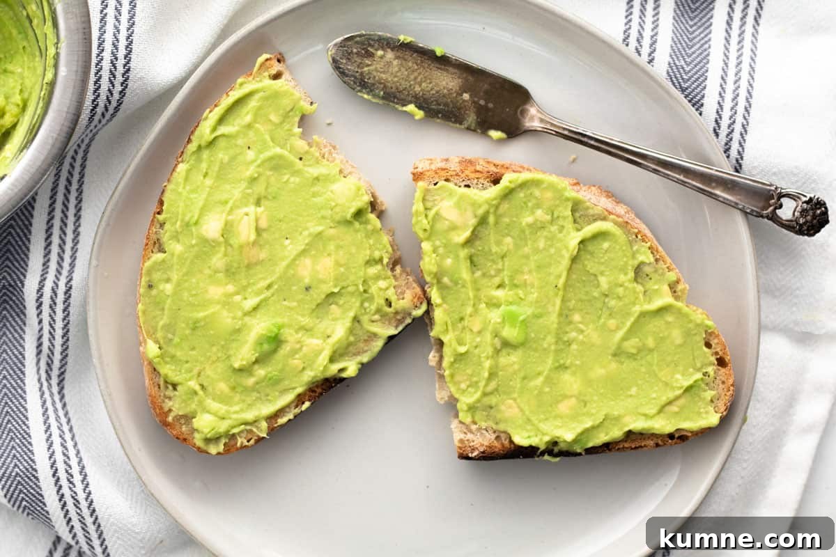Copycat Dunkin' Avocado Toast Recipe with 3 Ingredients 8 avocado spread on a cut piece of sourdough bread