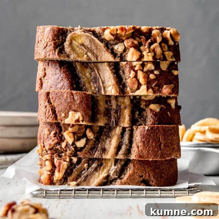 A stack of buckwheat banana bread slices on parchment paper.