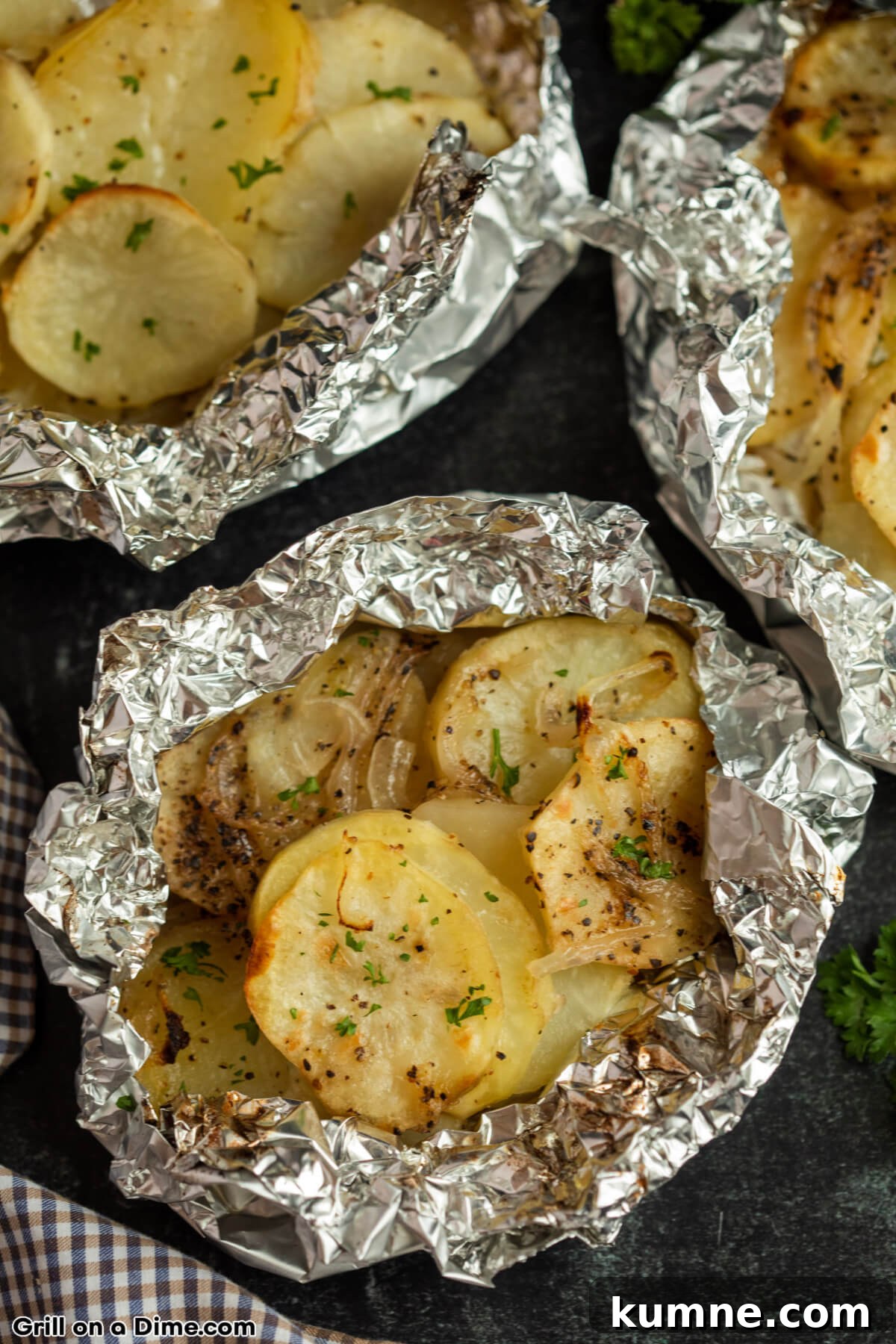 Crispy Foil-Grilled Potatoes with Garlic and Herbs 2 Potatoes in a foil pack that has been grilled